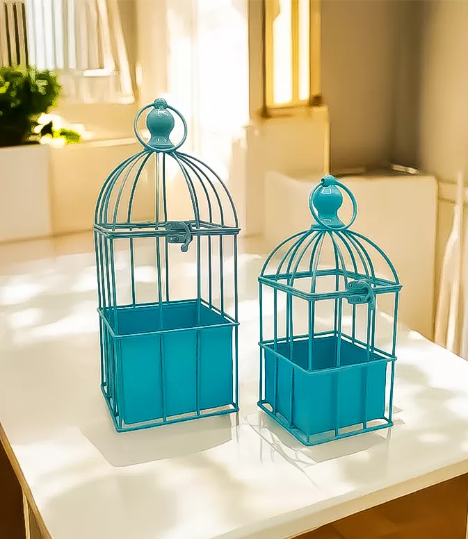 Two decorative blue bird cages on a white table for home decor