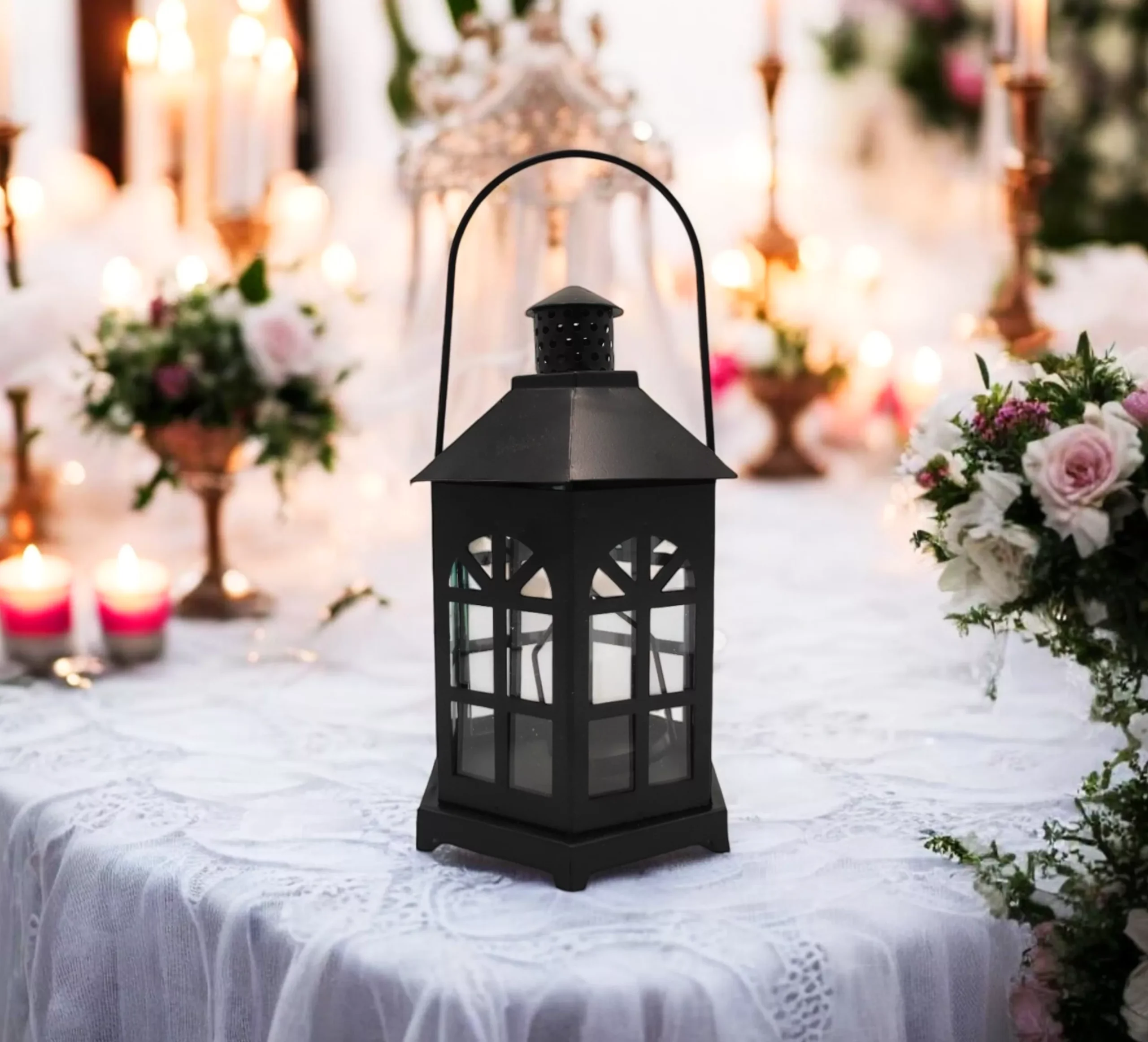 Black Metal Lantern on a decorated table with candles and flowers.
