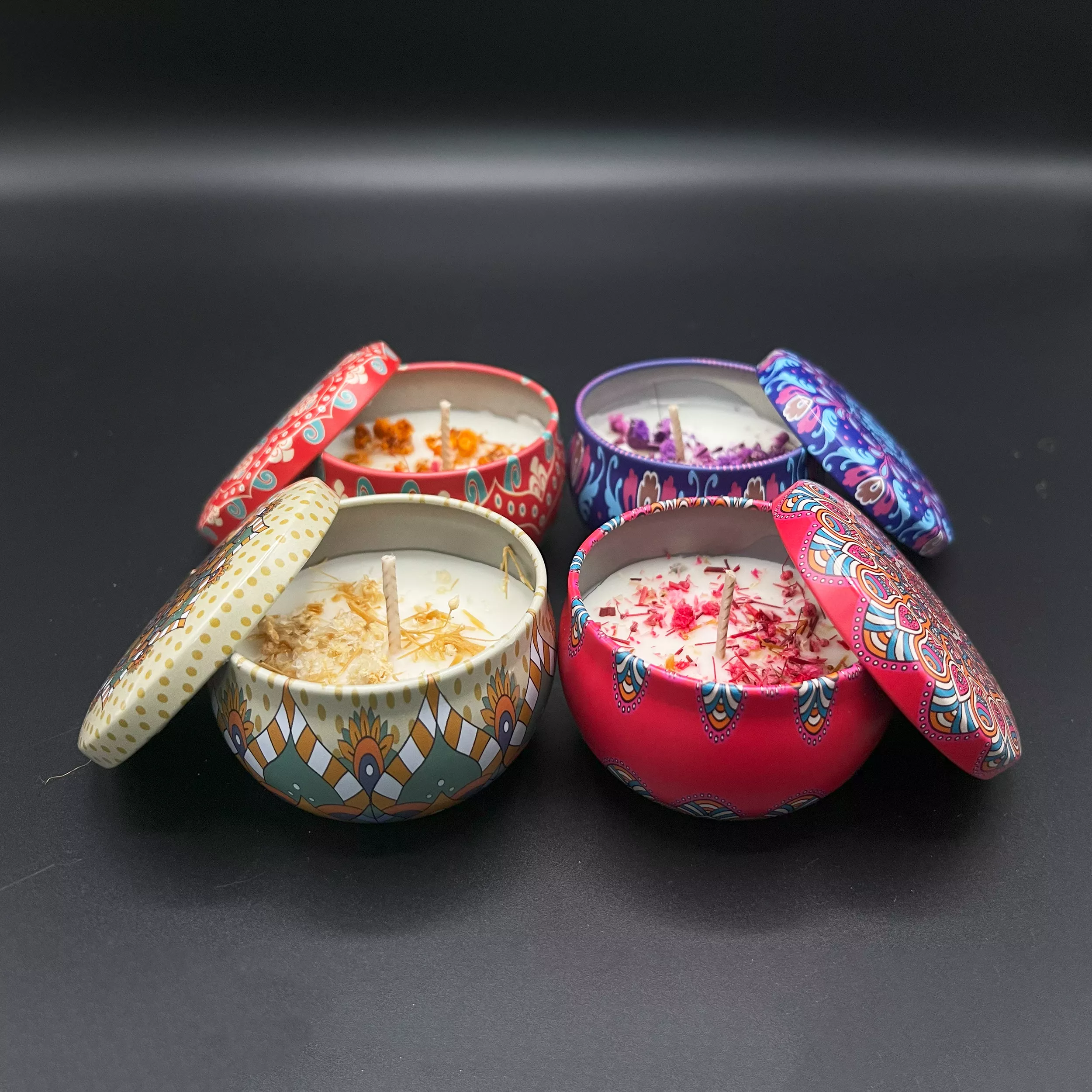 Four different Scented Candle tin jars with dried flowers