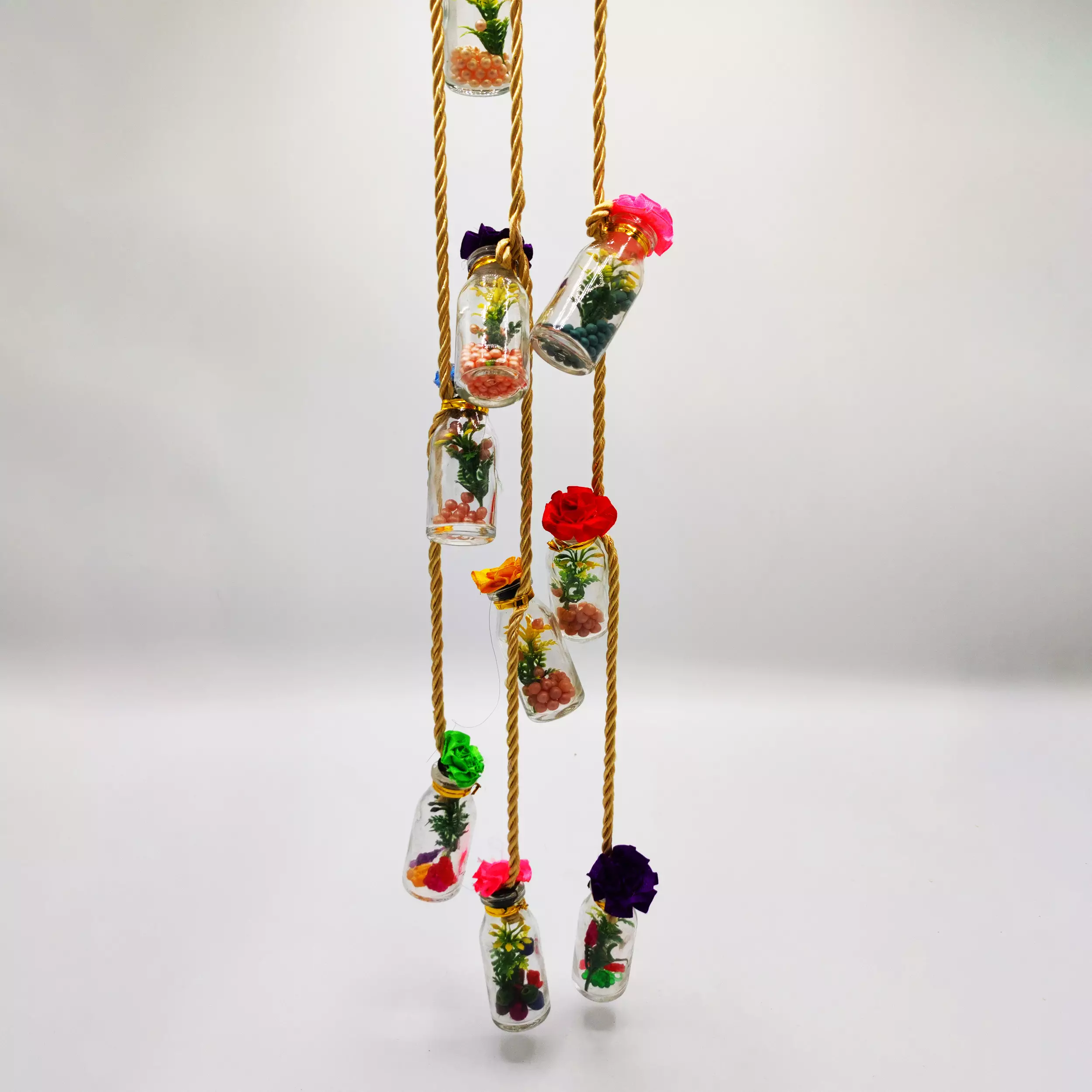 Hanging Wishing Bottles Hanging Chain with plants and flowers.